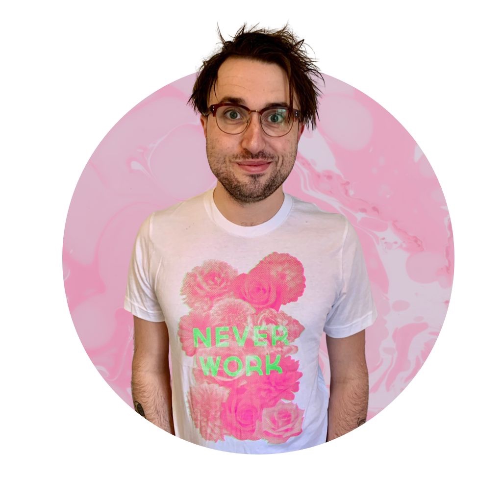 A picture of Liam in glasses and a white t-shirt with a pink print of roses with the words 'NEVER WORK' in green overlaid